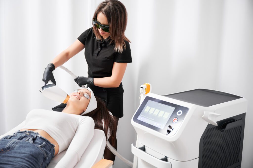 Woman receiving laser facial treatment in aesthetic clinic.