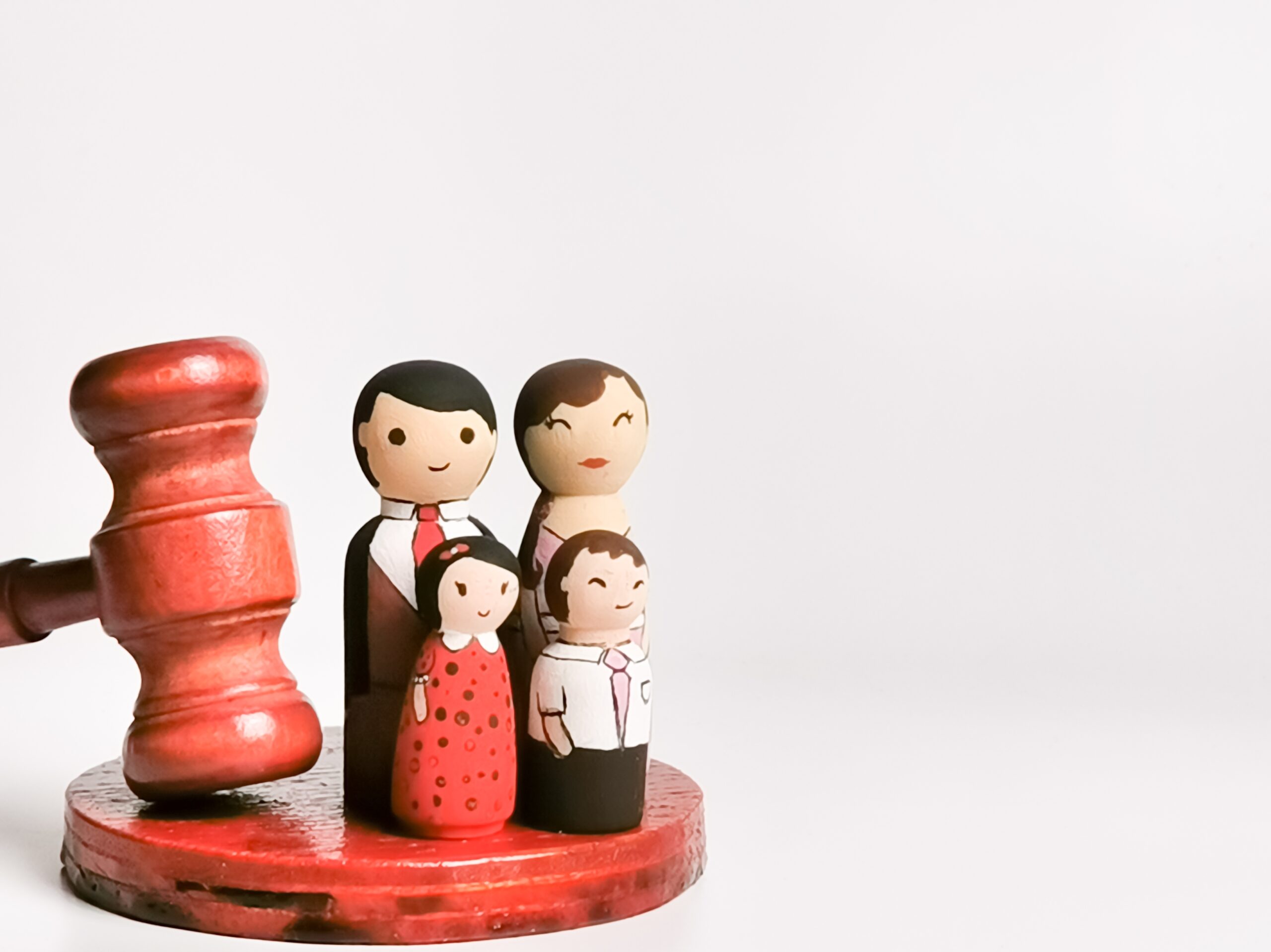 family law concept wooden dolls family with gavel 2023 11 27 05 20 03 utc scaled