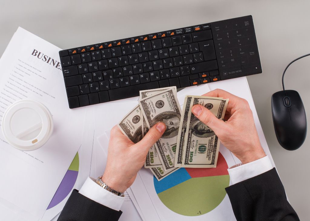 A businessman counting money for their budget to run a PPC campaign